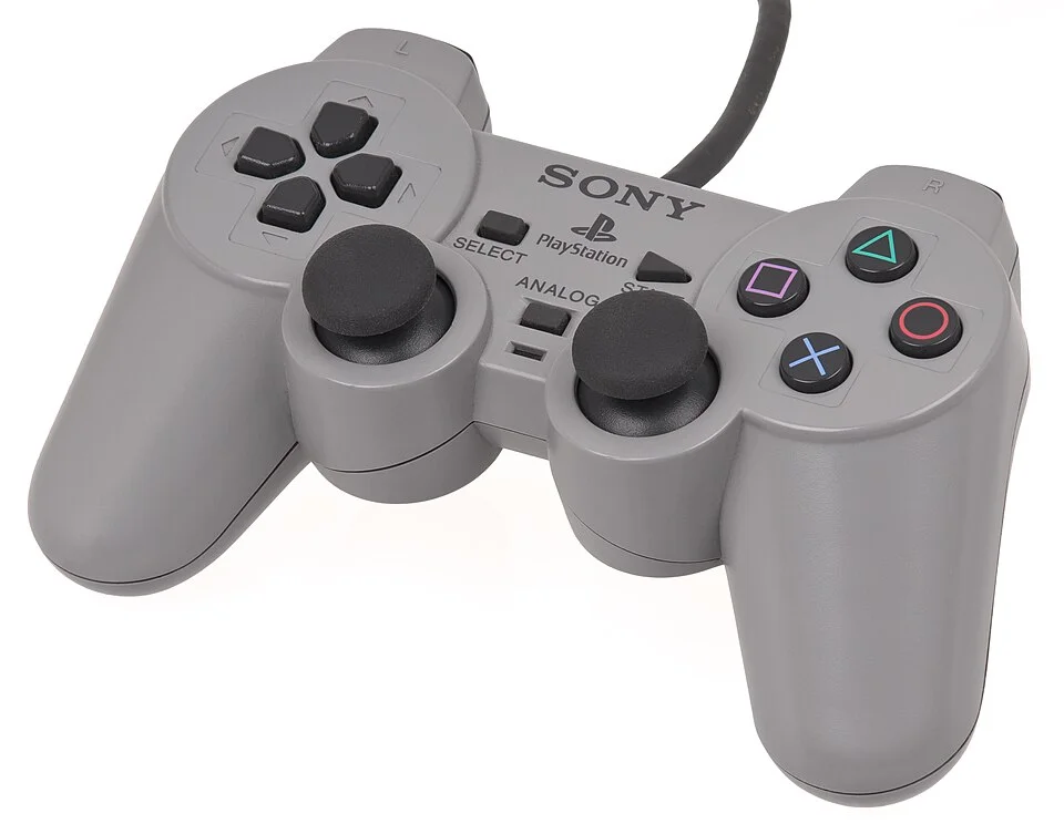 An original Sony PlayStation DualShock controller for the PlayStation video game console. This became the standard pack-in controller after its introduction, and replaced the non-analog controller.